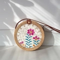 Handwoven round rattan crossbody bag with pink floral shell inlay and brown leather strap - Sunflower