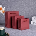 Three red small gift bags with matching woven rope handles in various mini sizes - Special Wine Red Card