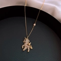 Golden unicorn pendant necklace with white cubic zirconia on a black leather tray - Gold Pegasus Style