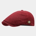 Close-up of dark red plaid newsboy cap with vintage m-logo badge and woven texture - Adjustable / Dark Red