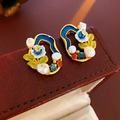 Macro shot of vintage gold flower earrings with blue enamel and pearls on leather box - Blue Flower Crystal Pearl Studs