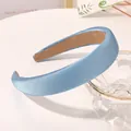 Close-up of light blue silk sponge headband with anti-slip inner lining on white surface - Denim Blue