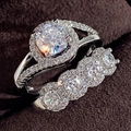Elegant silver engagement ring set with round halo moissanite and stone band - US 7 / White Gold