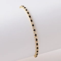 Detail of gold tennis bracelet featuring alternating blue and white cubic zirconia stones - Gold White Zircon + Royal Blue
