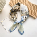 Elegant blue and gold baroque pattern silk scarf tied on a warm wooden display stand - Baroque Ornament Blue