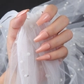 Detailed view of glossy nude pink coffin-shaped press-on nails with shiny UV finish - Flesh Pink (ZBLL-12)