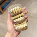 Elastic hair ties set in earthy tones inside a clear storage box for ponytails - Striped / 10 Pieces in Box / Khaki