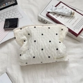 Detail of white seersucker makeup bag with black floral embroidery and brand label - Small Flower White