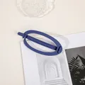 Detail of matte navy blue large hair clip on a minimalist lifestyle magazine layout - Oval - Royal Blue