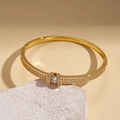 Close-up of 18K gold plated oval bangle featuring sparkling micro-pave cubic zirconia - Gold