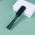 Dark green anti-static hair cushion brush with massage bristles on a white towel - Green Rectangular