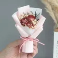 Close-up of small dried red rose bouquet with baby's breath and pink ribbon wrap - Dark Red Rose (Pink Wrapping)