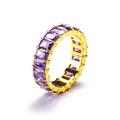Macro detail of the gold eternity ring featuring square-cut purple cubic zirconia stones - Gold Purple Zirconia