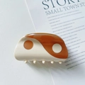 Top view of cream and brown Yin Yang acetate hair claw clip on lifestyle background - Brown / Small (6.5cm)