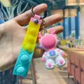 Pink astronaut keychain with colorful pop-it gradient strap and silver metal ring - Space Dragon Keychain / Pink