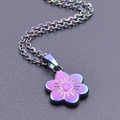 Detailed macro view of 18k gold plated iridescent flower pendant on a steel chain necklace - Iridescent Pendant Necklace