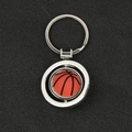 Silver keychain with a rotating orange basketball pendant in a metallic circular frame - Rotatable/Basketball