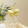 Cute yellow fabric bow keychain with white pearl ring and matching plastic clasp - Puff Yellow