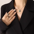 Silver necklace with green opal pendant and matching stone rings worn by a model - Silver Turquoise Style Necklace