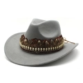 Detail of grey felt cowboy hat featuring golden skull trim and a dark brown feather - Gray