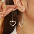 Sparkling gold dangling earrings with rhinestone heart pendant on female model - Gold White Rhinestone Long Dangle (DTE1316630GL-W)