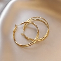 Large golden hoop earrings with textured hammered finish on champagne silk background - Double Hoop Style (HE3113)