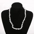 Close-up of natural irregular clear quartz crystal beaded necklace on black mannequin - Transparent/Rock Crystal