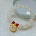 Ethnic bead bracelet with white cylinder beads, gold accents and a Ruyi lock pendant - White Copper Beads: White Peace Lock