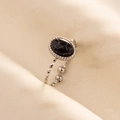 Macro shot of silver stainless steel adjustable ring with oval black patterned stone - Silver Base-Black Stone