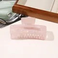 Detailed view of a pink marble texture hair claw clip made of durable acetate material - PVC 10.5cm Rectangular - Iridescent Pink