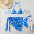 Three-piece bikini set with blue hibiscus print, sarong, and petal buckle on towel background - Blue