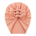 Detailed view of pink cotton baby turban featuring a decorative triple bow design - Ivory