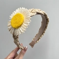 Close-up of woven straw headband featuring a large white daisy flower with yellow center - Sunflower + Beige Woven Headband