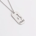 Macro shot of silver titanium steel necklace featuring hollow number 4 and LUCKY engraving - Number 4