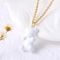 Golden chain necklace featuring a cute white resin bear pendant on a clean aesthetic background - White