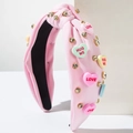 Cerchietto in tessuto rosa con nodo, strass e ciondoli a cuore LOVE per San Valentino - Rosa