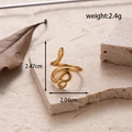 Adjustable gold-plated snake-shaped ring on marble background with leaf and dimensions - Snake Shape-Gold