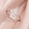 Elegant stainless steel cutout daisy flower ring on smooth pink silk fabric background - Hollow Floral B-Steel (282 Steel Color)