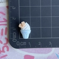 Macro view of a 1.5cm resin mini ice cream cupcake charm on a scale ruler - White Ice Cream Blue Cup