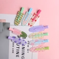 Set di 8 graziose mollette in acrilico con motivi colorati di frutta e quadretti - Multicolore