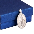 Silver oval stainless steel Virgin Mary pendant resting on a navy blue gift box - 2*3cm / Steel