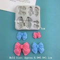 Molde de silicona con 4 lazos de mariposa para fondant y chocolate sobre fondo azul - Lazo de 4 Cavidades / Gris