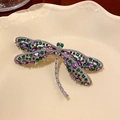 Macro shot of silver dragonfly brooch with purple and green stones on a porcelain plate - Drip Oil Contrast Color Zircon Dragonfly (5#)