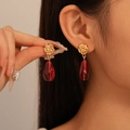 Vintage gold rose stud earrings with red faceted teardrop pendant on female model - Rose Red Teardrop Dangle Earrings (925 Sterling Silver Earring Post)