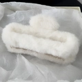 Close-up of soft white plush hair claw clip featuring fluffy faux fur on tissue paper - 12CM Rectangle / White