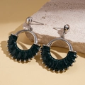 Macro detail of dark green leather wrapped C-shape hoop earrings on a stone base - Green