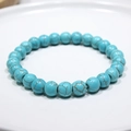 Close-up of turquoise beaded bracelet with natural brown veins on a white ceramic tray - 12# (Sky Blue Crackle Turquoise)