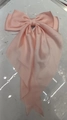 Elegant solid light pink satin hair clip featuring a large layered bow and long ribbons - Light Pink
