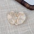 Detail of elegant acetate orchid hair clip with marble texture and pearl center - Milk White