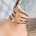 Three-piece black cord anklet set with golden triple linked heart pendants on ankle - Black Rope Gold Triple Heart Style - 3 Pcs Set